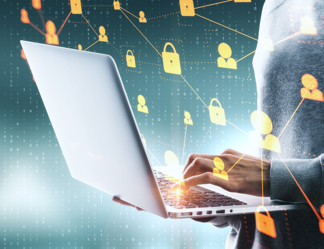 Man solving cybersecurity threat on a laptop